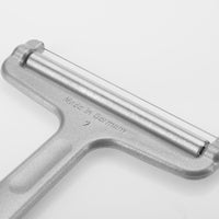 Front view of Westmark Germany wire cheese slicer in silver color featuring a strong stainless steel frame and adjustable wire for uniform cheese slicing.